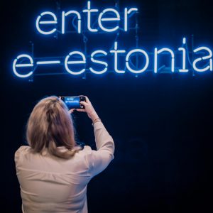 2739-woman-taking-photos-of-enter-e-estonia-sign-jelena-rudi-319268-1-1800×1198